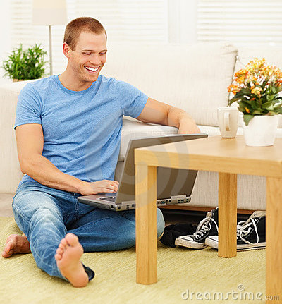 happy-relaxed-guy-using-laptop-home-10745818.jpg