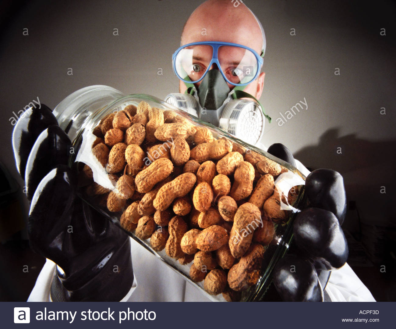food-allergies-peanut-allergy-man-holding-jar-of-peanuts-with-protective-ACPF3D.jpg