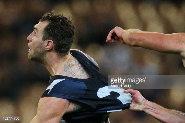 452774790-travis-cloke-of-the-magpies-is-held-in-a-gettyimages.jpg