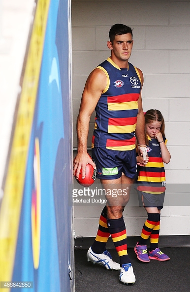 468642850-taylor-walker-of-the-crows-walks-out-with-a-gettyimages.jpg
