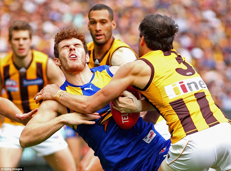 2D0814A900000578-3258414-Luke_Shuey_of_the_Eagles_is_tackled_by_Jordan_Lewis_of_the_Hawks-a-53_1443852979383.jpg