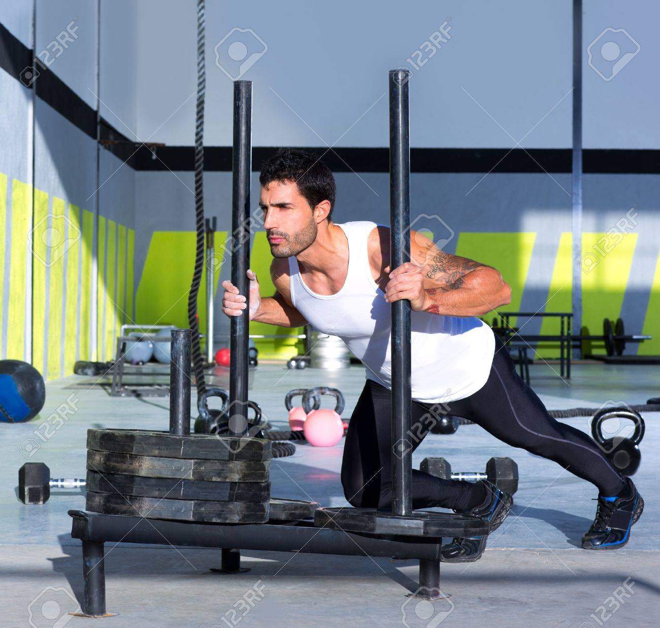 17050638-crossfit-sled-push-man-pushing-weights-workout-exercise.jpg