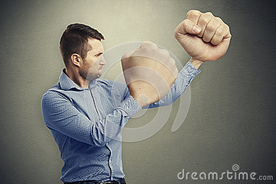 serious-man-big-fists-funny-picture-over-grey-background-52211846.jpg