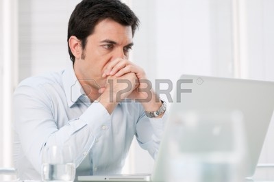 13025739-pensive-absorbed-business-man-watching-at-computer-laptop-with-worried-expression.jpg