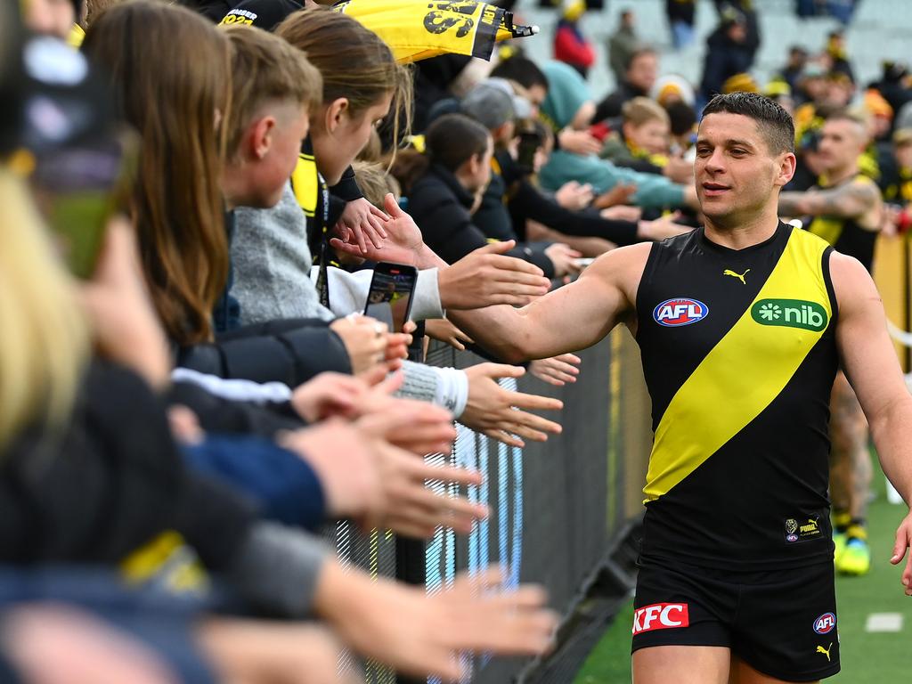 [PLAYERCARD]Dion Prestia[/PLAYERCARD] of the Tigers high fives fans after a win last season. Picture: Quinn Rooney/Getty Images.