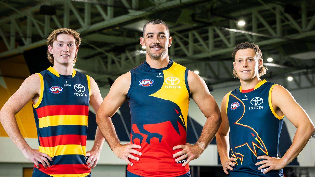 Max Michalanney, [PLAYERCARD]Taylor Walker[/PLAYERCARD] and Jake Soligo in the Crows' guernsey range for 2024.