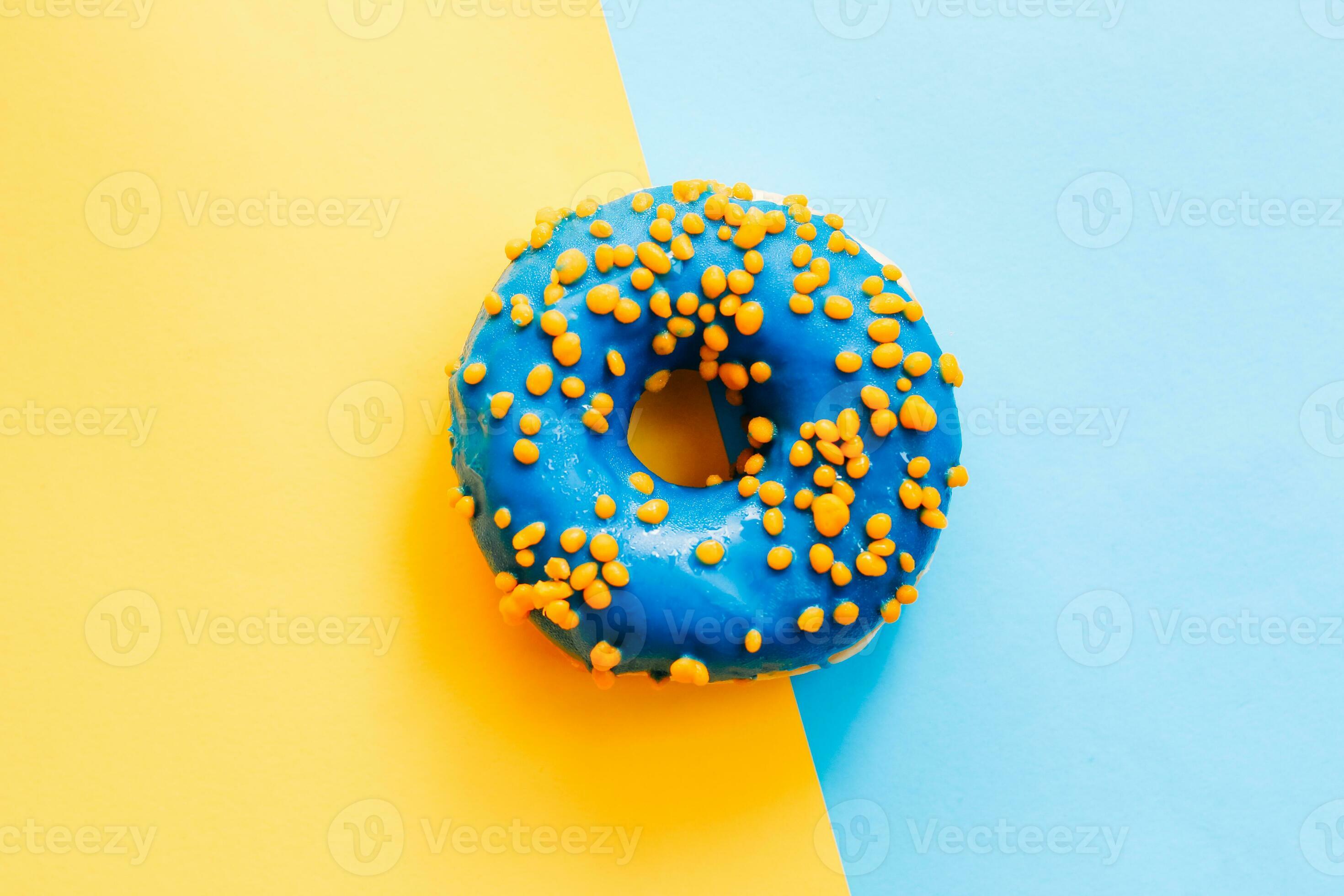 blue-yellow-glaze-donut-on-blue-yellow-paper-photo.JPG
