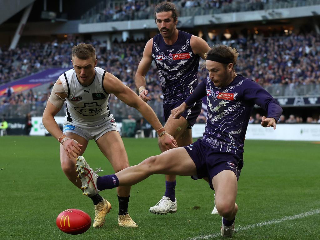 [PLAYERCARD]James Aish[/PLAYERCARD] and [PLAYERCARD]Alex Pearce[/PLAYERCARD] take on Carlton’s [PLAYERCARD]Patrick Cripps[/PLAYERCARD] in round 17 at Optus Stadium. Picture: Paul Kane/Getty Images