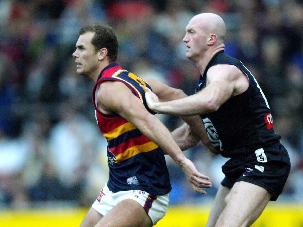 Martyn (right) in his Carlton days, battles former teammate Wayne Carey.