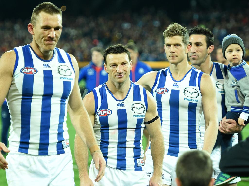 North Melbourne champions, Drew Petrie, Brent Harvey, Nick Dal Santo and Michael Firrito after their final game for the club in 2016. Picture: Tom Huntley