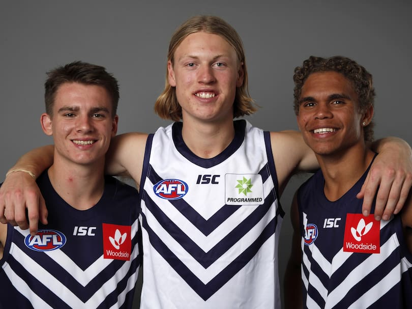 Caleb Serong (L - Pick 8), Hayden Young (Pick 7) and Liam Henry of the Fremantle Dockers (R - Pick 9) pose for a photo.