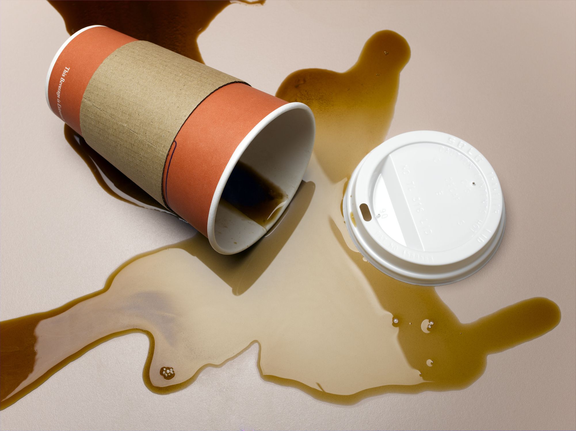 vending-cup-on-side-spilling-coffee-onto-surface-royalty-free-image-1651507034.jpg
