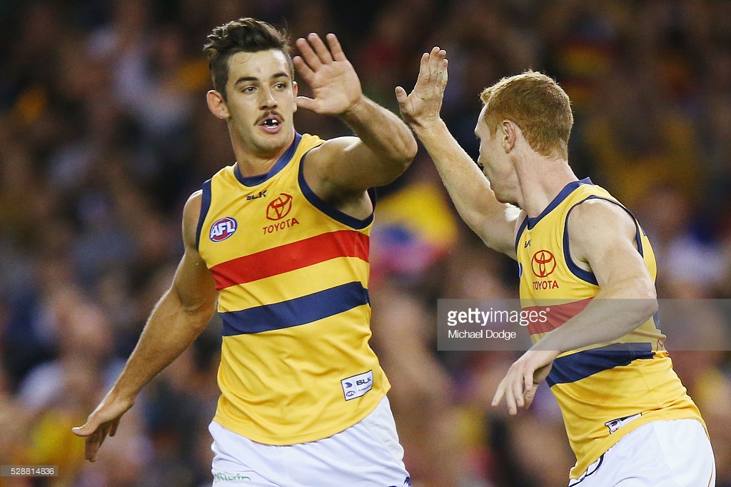 tom-lynch-of-the-crows-celebrates-a-goal-with-taylor-walker-during-picture-id528814836