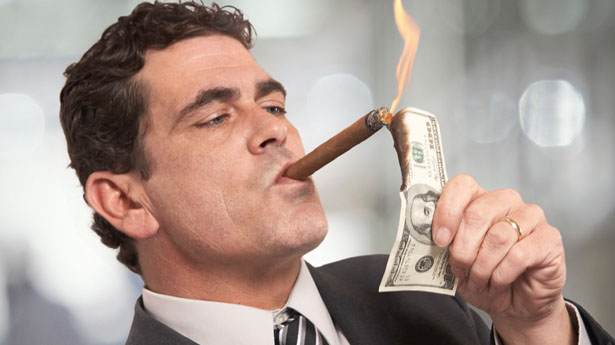 Rich-Businessman-Lighting-Cigar-With-100-Dollar-Bill.jpg