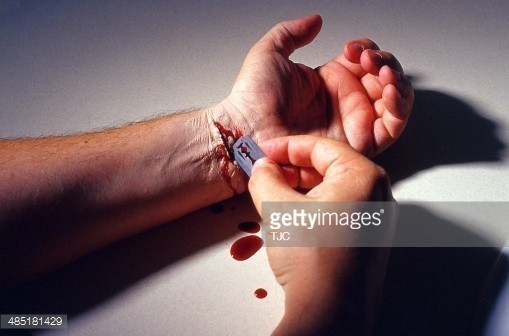 485181429-man-slitting-his-wrist-with-a-razor-gettyimages.jpg