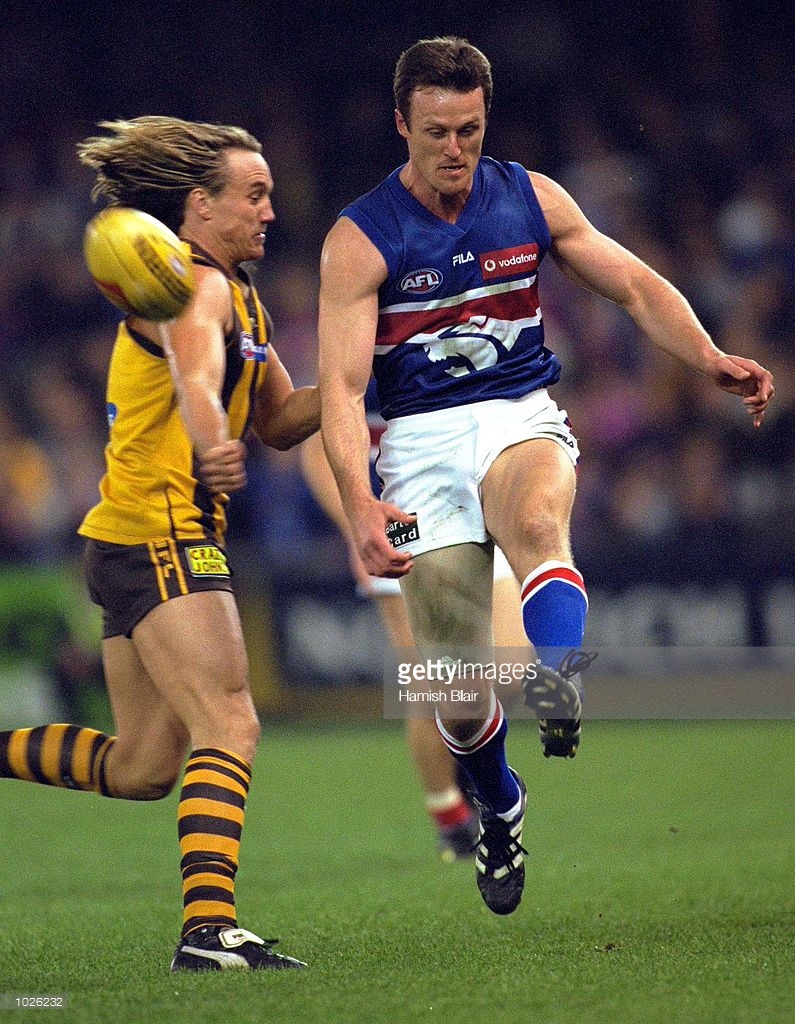 aug-2000-chris-grant-for-the-bulldogs-kicks-clear-of-daniel-chick-for-picture-id1026232