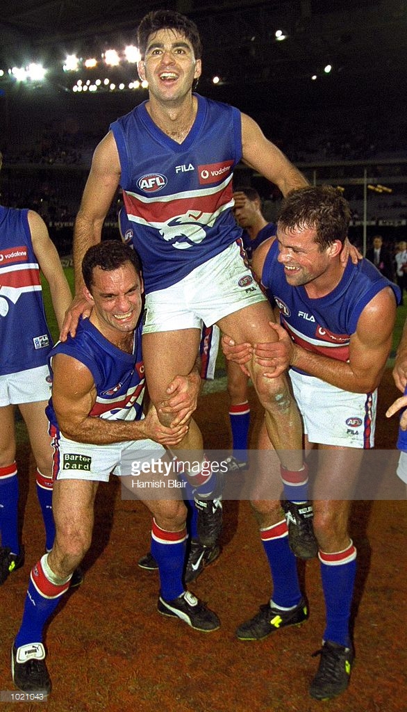 jul-2000-tony-liberatore-and-brad-johnson-struggle-to-lift-jose-for-picture-id1021043