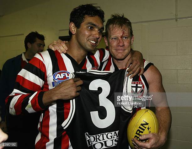 nathan-burke-of-the-saints-hands-over-his-jumper-to-teammate-xavier-picture-id2390192