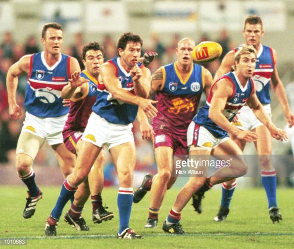 sep-1999-paul-hudson-for-the-western-bulldogs-hand-passes-as-chris-picture-id1010863