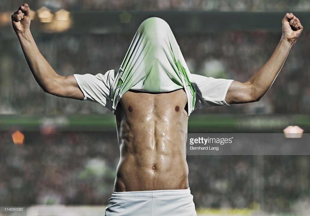 soccer-player-football-shirt-over-head-celebratin-picture-id114050020