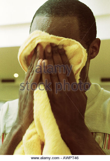 man-wiping-off-face-with-towel-close-up-awpt46.jpg