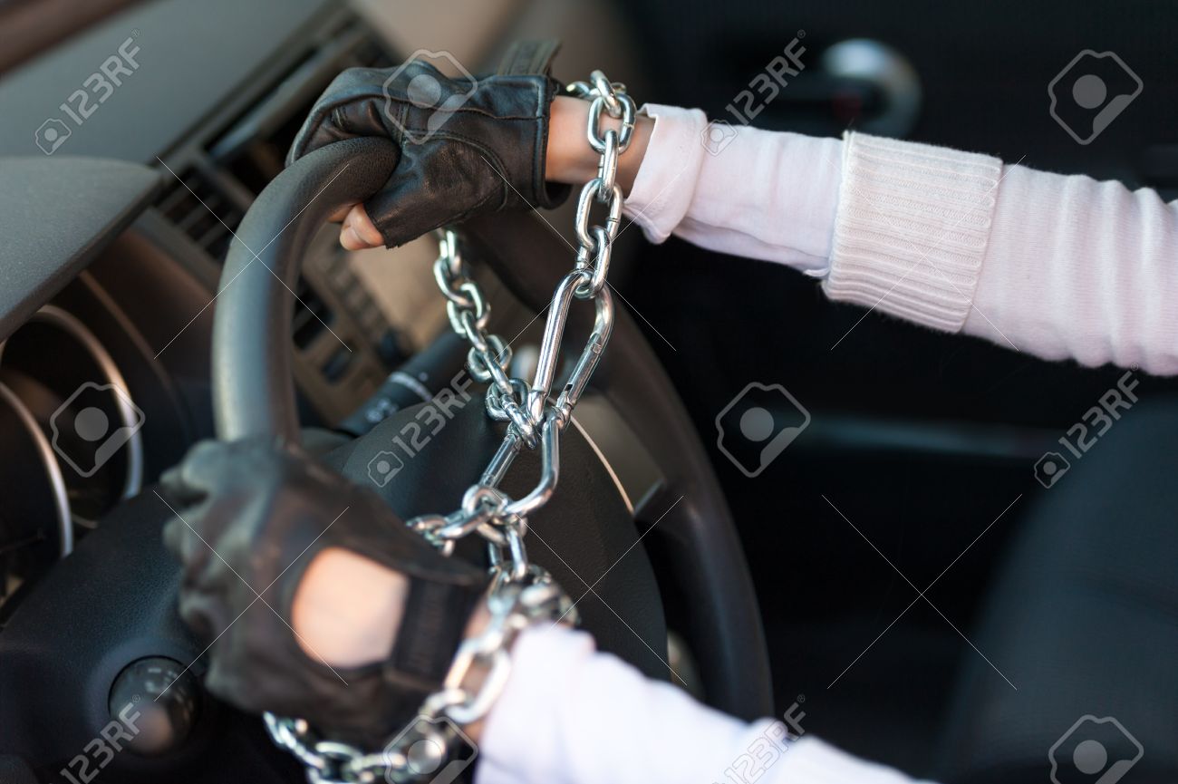 18854781-Chained-to-Steering-Wheel-Stock-Photo-gloves-driving.jpg