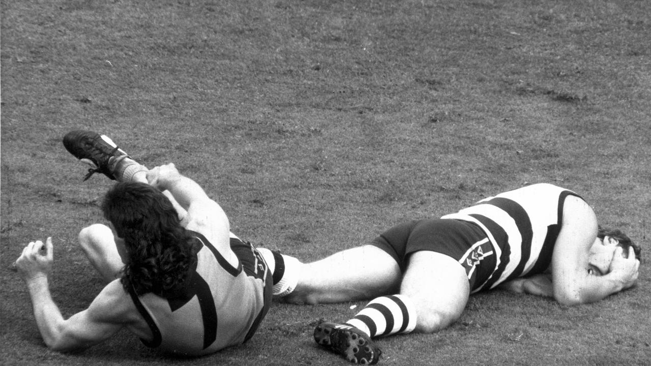 Ablett holds his head after a fierce clash with Gary Ayres in the 1989 Grand Final. Picture: Craig Borrow