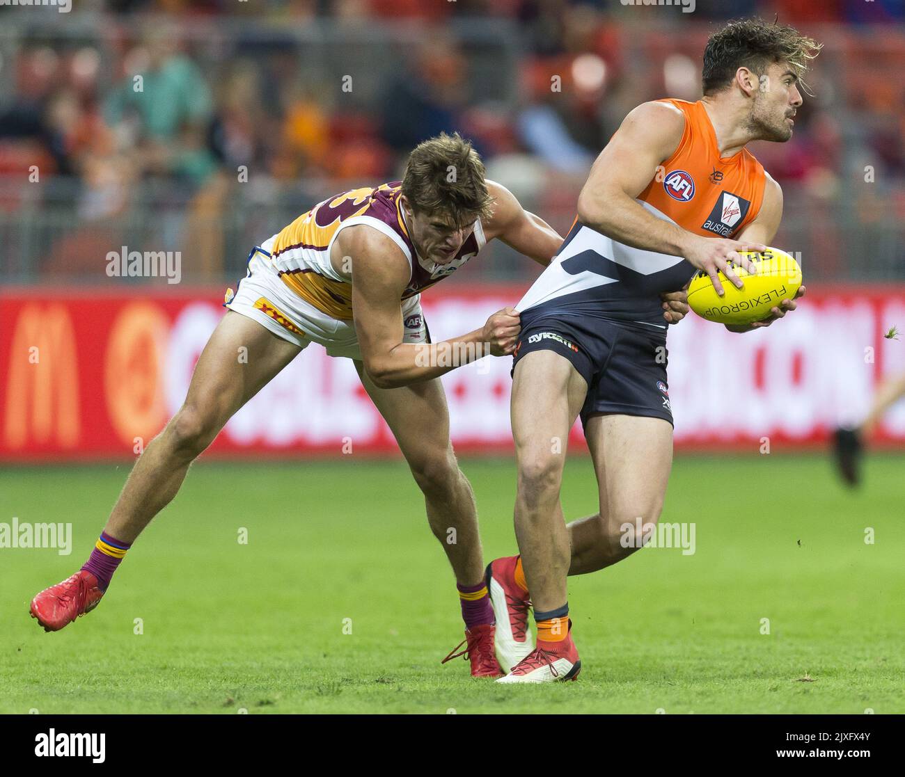 stephen-coniglio-of-the-giants-is-tackled-by-zac-bailey-of-the-lions-during-the-round-6-afl-match-between-the-greater-western-sydney-gws-giants-and-the-brisbane-lions-at-spotless-stadium-in-sydney-saturday-april-28-2018-aap-imagecraig-golding-2JXFX4Y.jpg
