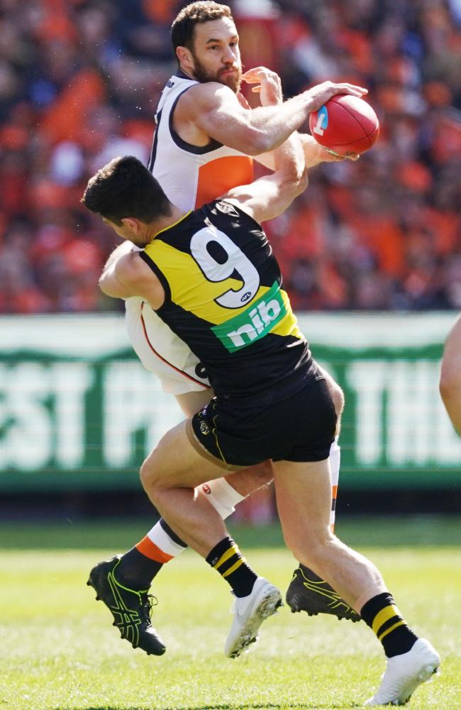 Trent Cotchin sets the tone for the Tigers with a huge tackle on Shane Mumford.