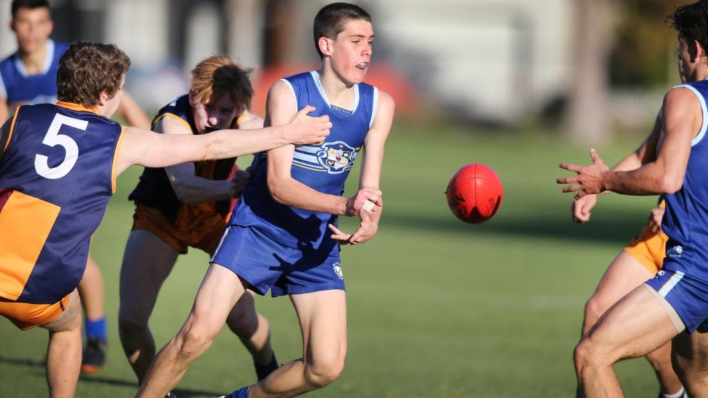 Sacred Heart’s Will Day handballs to team mate Max Harry last season. Picture: AAP/Dean Martin