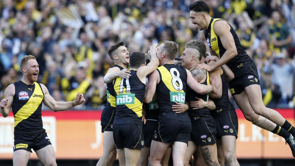 Players swamp Pickett after he booted a third-term goal. Picture: David Caird