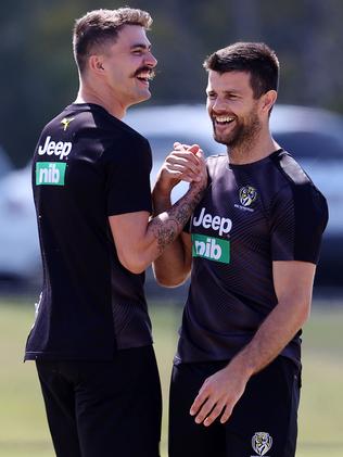 Cotchin and Oleg Markov share a laugh at a training session.