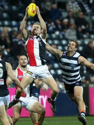 Callum Wilkie takes a strong mark in front of Geelong’s Tom Hawkins. Picture: George Salpigtidis/AAP