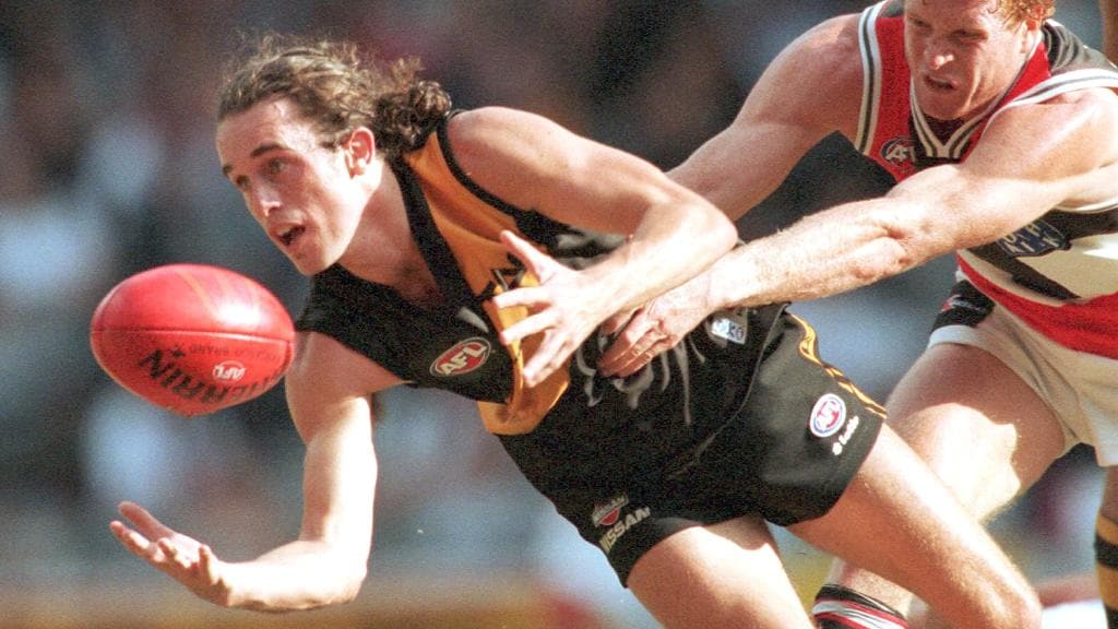 Clinton King tries to break the Tony Delaney tackle in 2000.