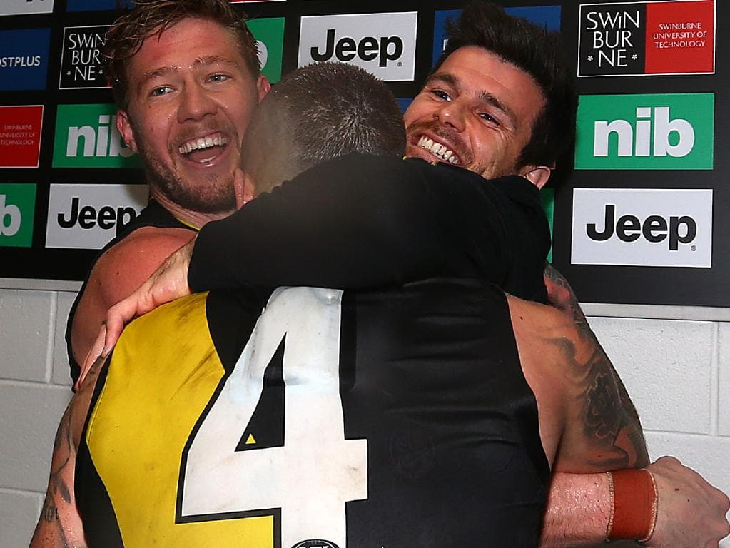 Trent Cotchin embraces Tiger teammate and close friend Dustin Martin.