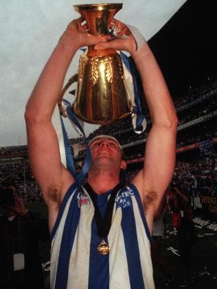 Corey McKernan celebrates with the 1996 premiership cup.