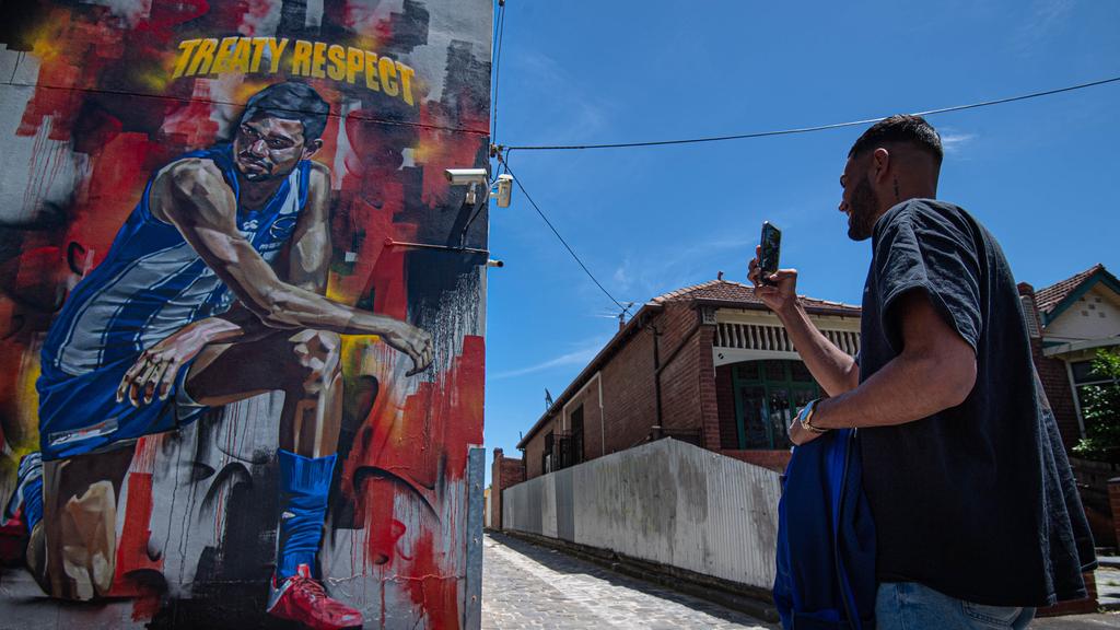 [PLAYERCARD]Tarryn Thomas[/PLAYERCARD] in front of the Black Lives Matter mural of him. Picture in North Melbourne: Jason Edwards