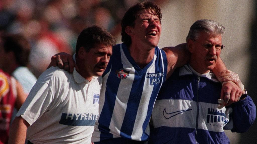 Corey McKernan is carried from the field during the preliminary final.