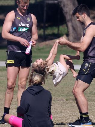 Trent Cotchin with his oldest daughter, Harper, as wife Brooke looks on at training in the hub. Picture: Michael Klein