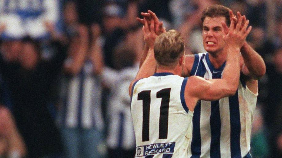 Wayne Carey and Glenn Archer during their playing days.