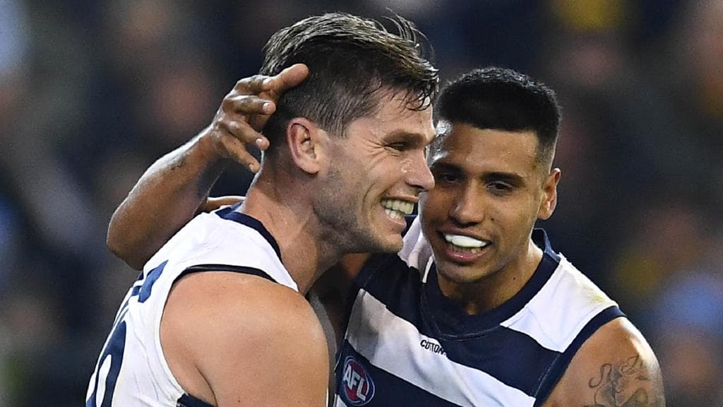 Tim Kelly celebrates a goal with Geelong teammate Tom Hawkins. Picture: Quinn Rooney/Getty Images.
