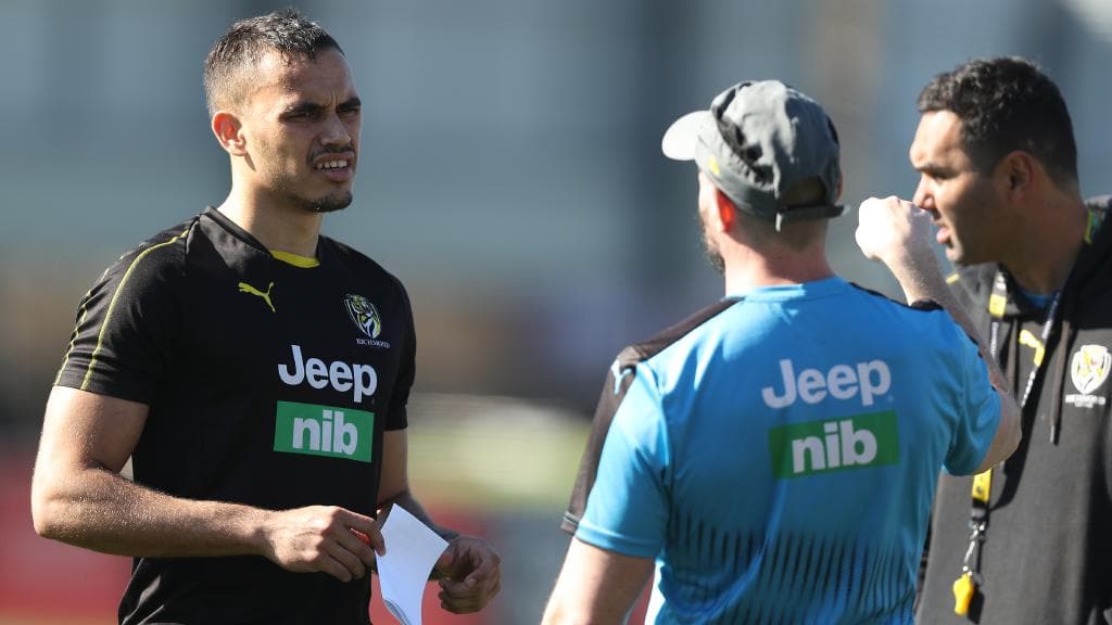 Sydney Stack talks with Richmond coaches on the training track as he attempts an injury comeback.