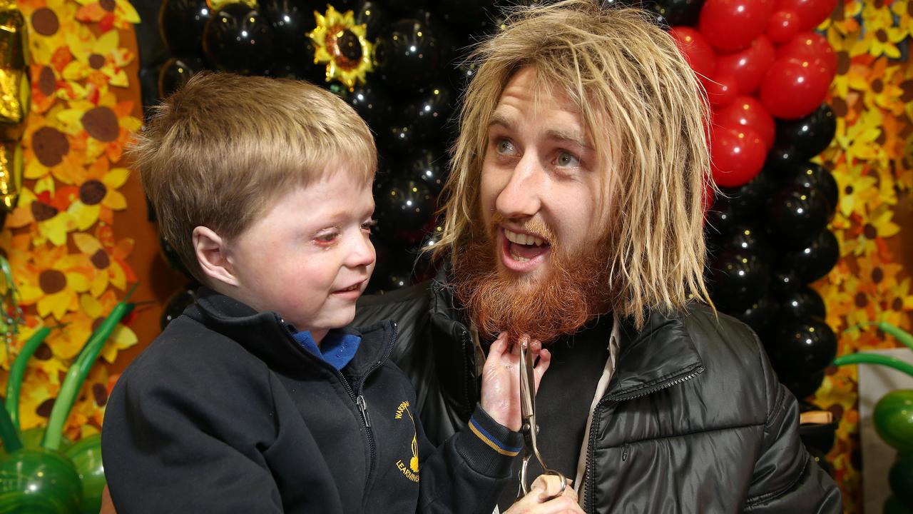 Harrison Pennicott and Dyson Heppell during their beard shaving fundraiser in 2018, which raised more than $60,000 for scleroderma Victoria. Pic: Michael Klein