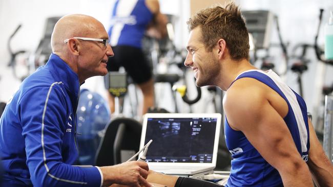 Shaun Higgins with physio Steve Saunders. Picture: Hamish Blair