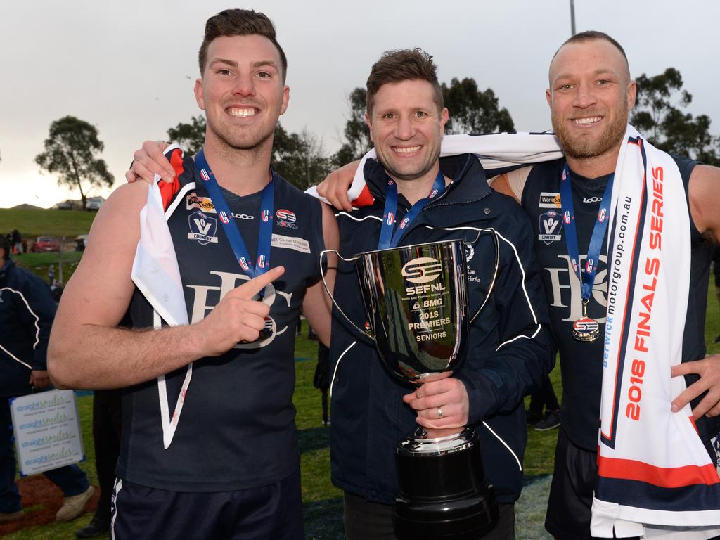 Bryce Rutherford (left) with coach Stewart Kemperman and Madison Andrews after Berwick’s 2018 premiership.