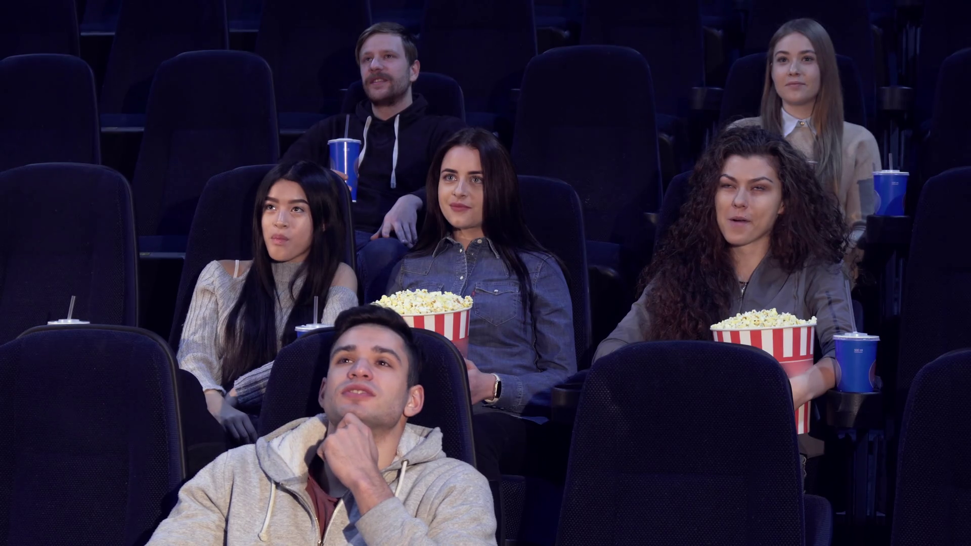 young-people-watching-movie-at-the-movie-theater-two-boys-and-four-girls-sitting-on-different-rows-at-the-cinema-asian-teenage-girl-talking-to-caucasian-girl_hfenlwxvrg_thumbnail-full01.png