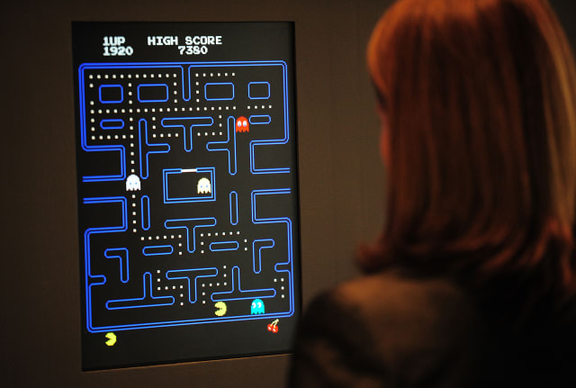 Paola Antonelli, senior curator of architecture and design at the Museum of Modern Art (MoMA)  plays Pac-Man at an exhibition preview in 2013. 