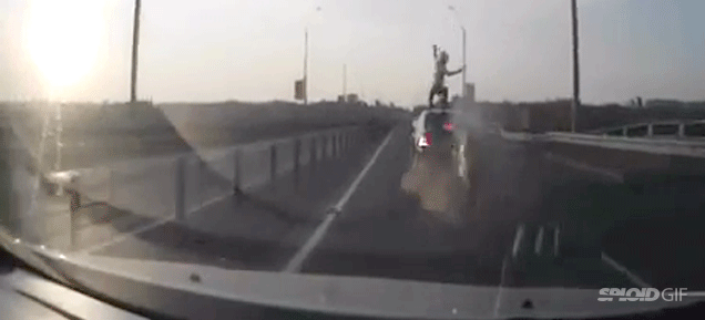 Motorcyclist crashes, flips and sticks a perfect landing on a car's roof