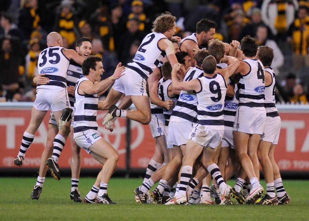 Geelong celebrate on top of Tom Hawkins after he kicked the ...