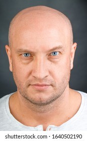 portrait-bald-man-blue-eyes-260nw-1640502190.jpg